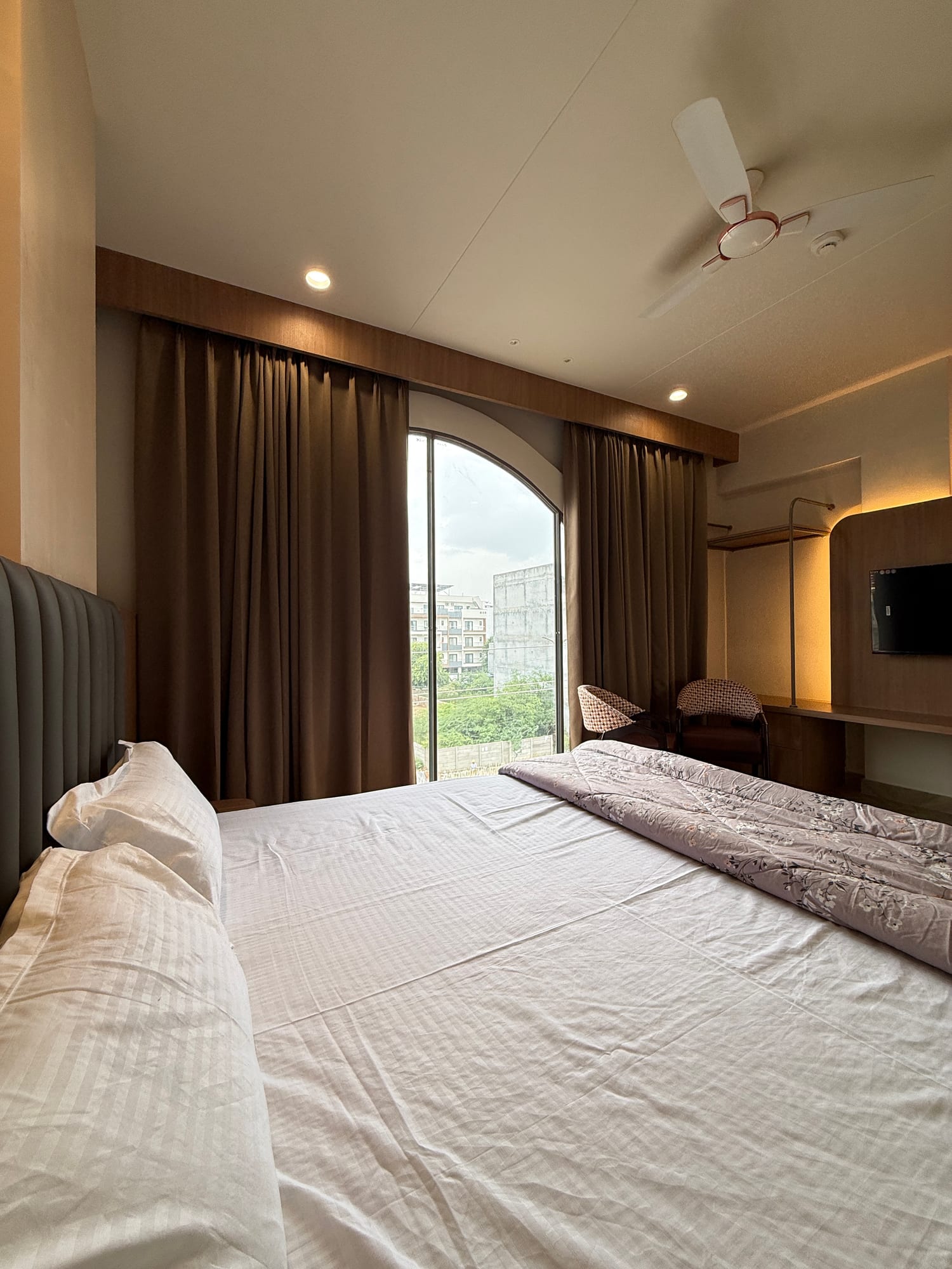Premium room overview with TV console and seating